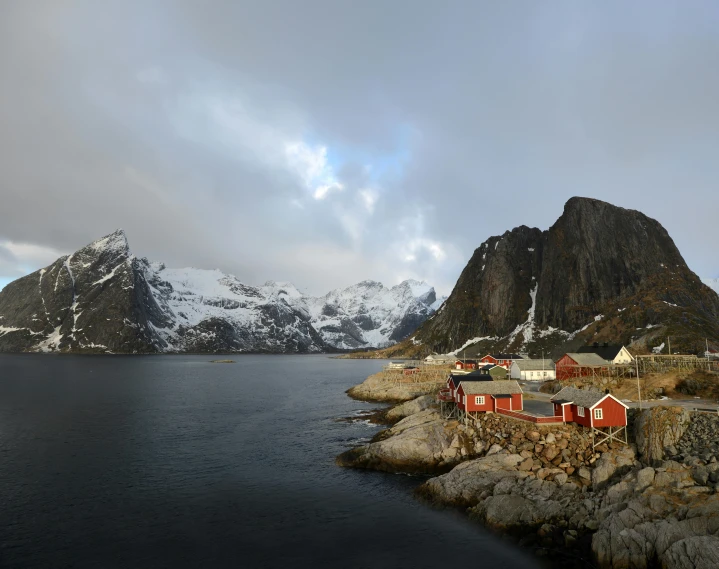 a body of water with a mountain in the background, by Harald Giersing, pexels contest winner, hurufiyya, several cottages, gungnir, conde nast traveler photo, 4k)