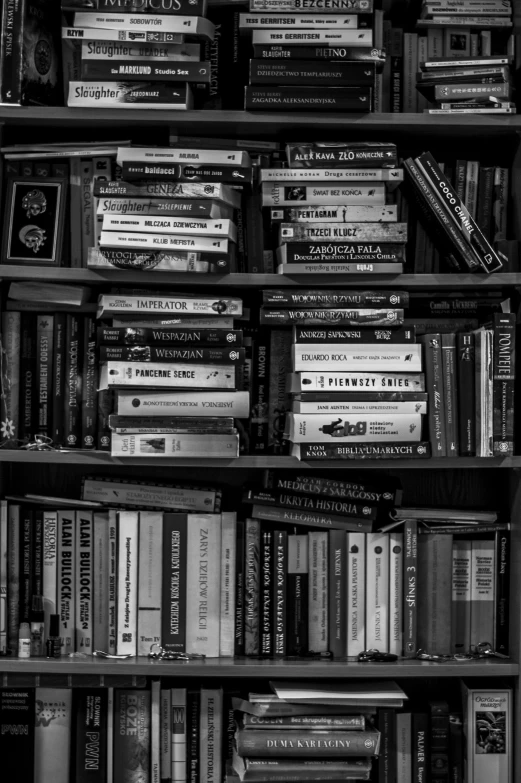 a black and white photo of a bookshelf full of books, a black and white photo, by Felix-Kelly, nostalgic, van, featured, technical