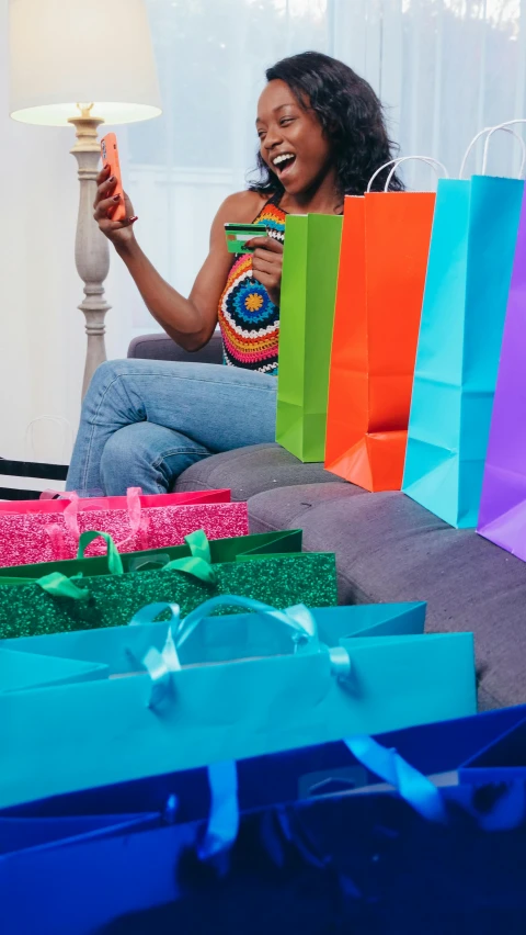 a woman sitting on a couch with shopping bags, maximalism, african ameera al taweel, getty images, lgbtq, snapchat photo