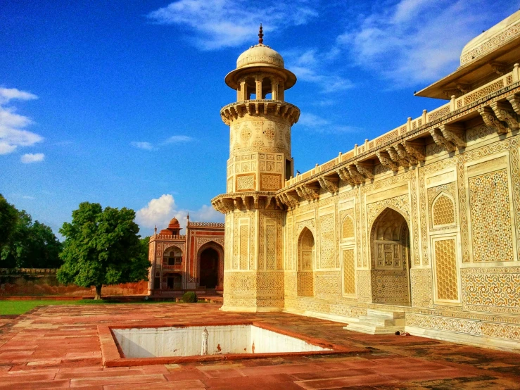 a building with a tower in the middle of it, inspired by Steve McCurry, arabesque, taj mahal, gopro photo, ancient”