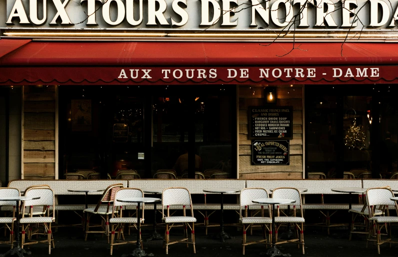 a restaurant with tables and chairs in front of it, inspired by Pierre Toutain-Dorbec, pexels contest winner, film noirs, shop front, brown, touring