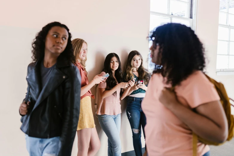 a group of women standing next to each other, trending on pexels, happening, looking around a corner, black teenage girl, bullying, background image