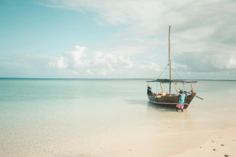 a boat sitting on top of a beach next to the ocean, hurufiyya, light blue water, unmistakably kenyan, vintage color, moana