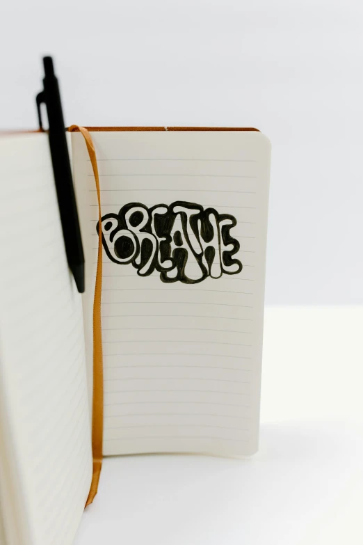 a notebook with a pen sitting on top of it, featured on behance, graffiti, breathe, paper cut out, thumbnail, medium close shot