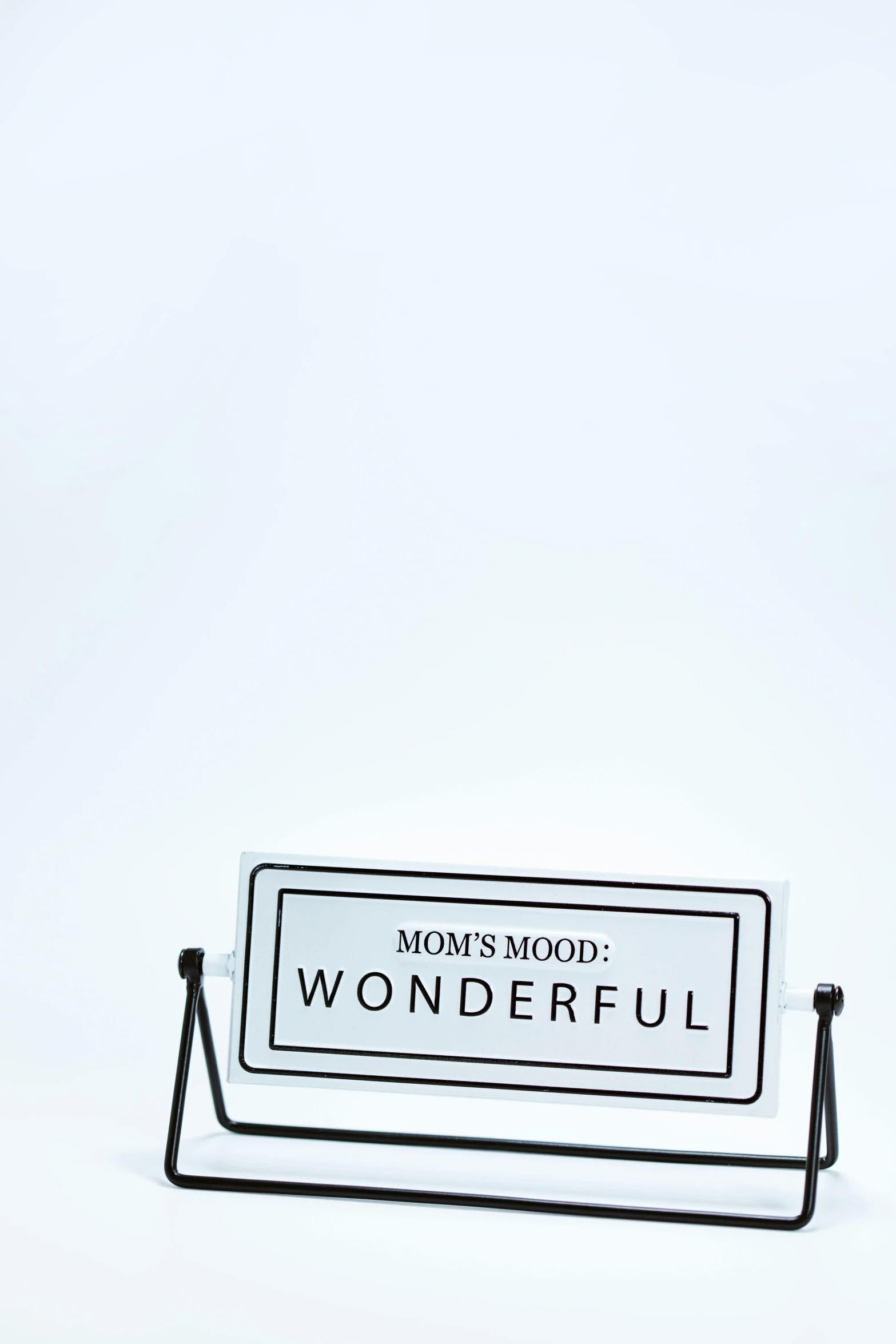 a sign sitting on top of a metal stand, by Carey Morris, unsplash, pop figure of mom with long, wonderful, on white background, wonderous