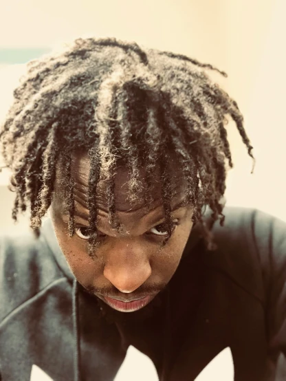 a man with dreadlocks using a cell phone, an album cover, inspired by Eugene Leroy, unsplash, hurufiyya, he looks like tye sheridan, loosely cropped, me, staring you down