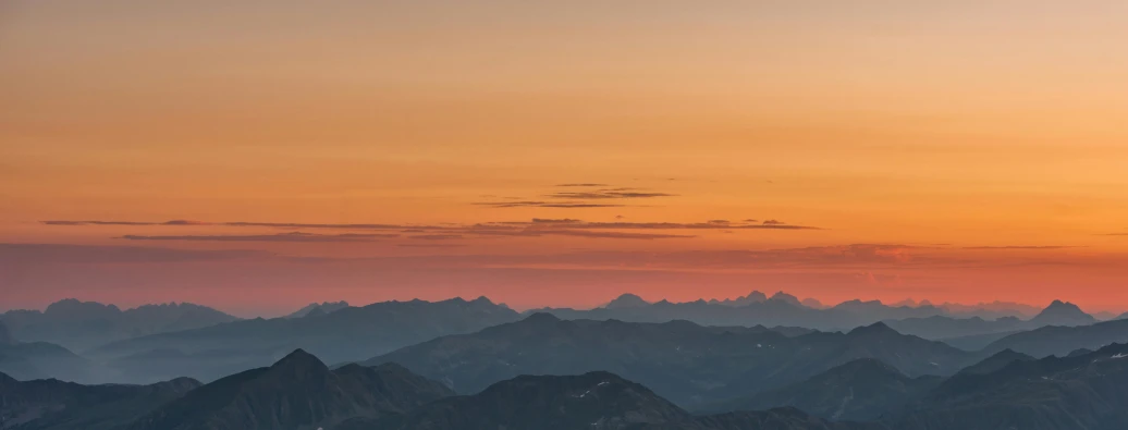 a view of a mountain range at sunset, by Peter Churcher, pexels contest winner, warm sunset colors, subtle detailing, dusk sky, high altitude