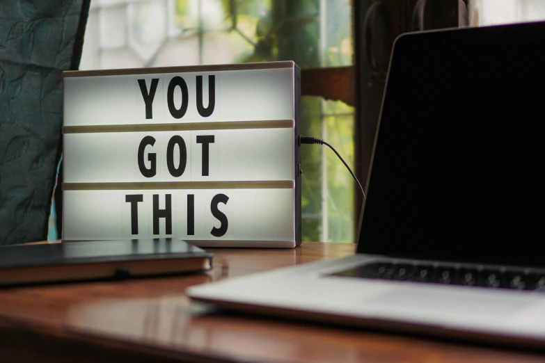 a laptop computer sitting on top of a wooden desk, pexels contest winner, happening, bright signage, motivational, you, this is it