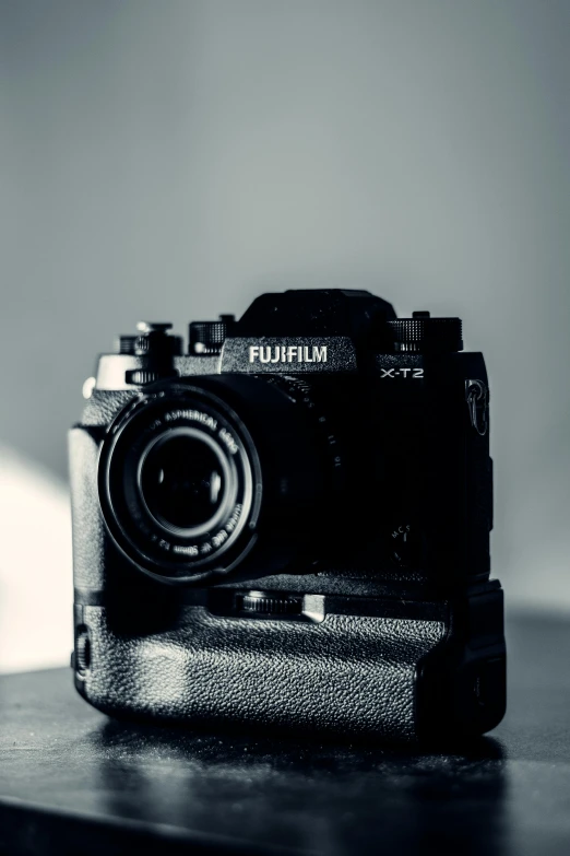 a black and white photo of a camera, unsplash, photorealism, fujifilm x-t3, blue tint expired film, furry shot, medium format. soft light