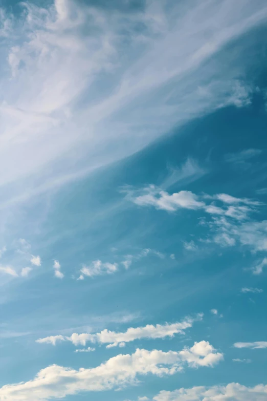 a man flying a kite on top of a lush green field, trending on unsplash, minimalism, layered stratocumulus clouds, light blues, rectangle, long