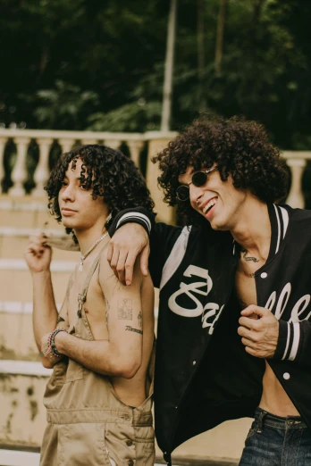 a group of young men standing next to each other, an album cover, trending on pexels, curly black hair, portrait of two people, brazil, shady look