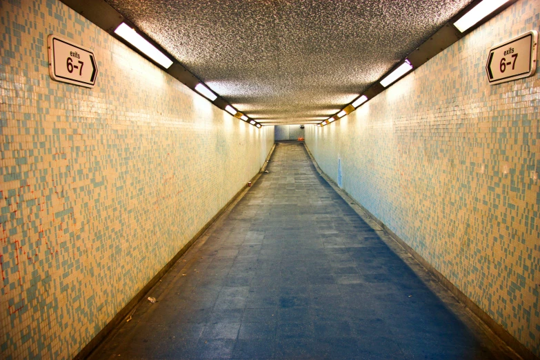 a long hallway with a light at the end of it, london south bank, tunnels, tiled, profile image