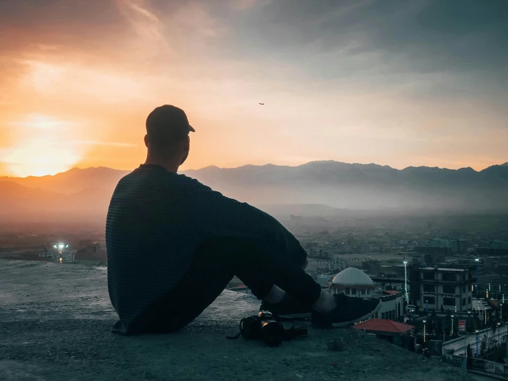 a man sitting on top of a hill with a skateboard, pexels contest winner, realism, end of the day, profile image, an arab standing watching over, sitting on edge of bed