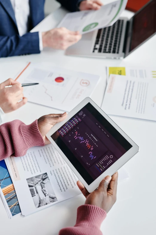 a group of people sitting around a table with laptops, trending on unsplash, analytical art, waveforms on top of square chart, high quality photo, thumbnail, holding close