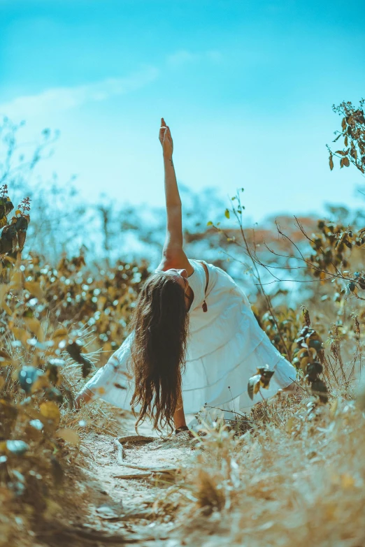 a woman in a white dress doing a yoga pose, pexels contest winner, connected to nature via vines, waving robe movement, hippie, back pose