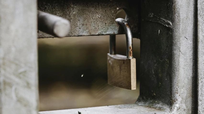 a close up of a lock on the side of a building, by Jesper Knudsen, unsplash, private press, close up shot a rugged, on a wooden table, closeup of magic water gate, thumbnail