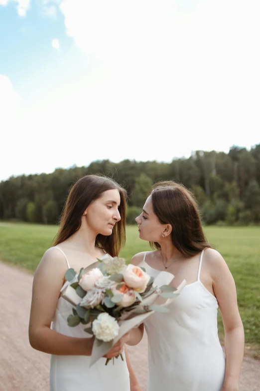 two women standing next to each other on a dirt road, a picture, unsplash, romanticism, bouquet, 15081959 21121991 01012000 4k, lesbian kiss, closeup portrait shot