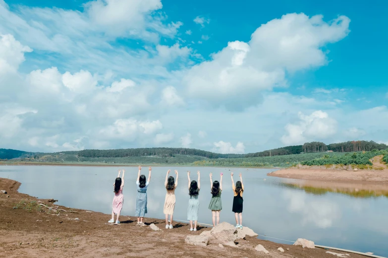 a group of people standing next to a body of water, by Kim Tschang Yeul, pexels contest winner, land art, cute girls, blue sky, ulzzang, ( ( ( ( kauai ) ) ) )