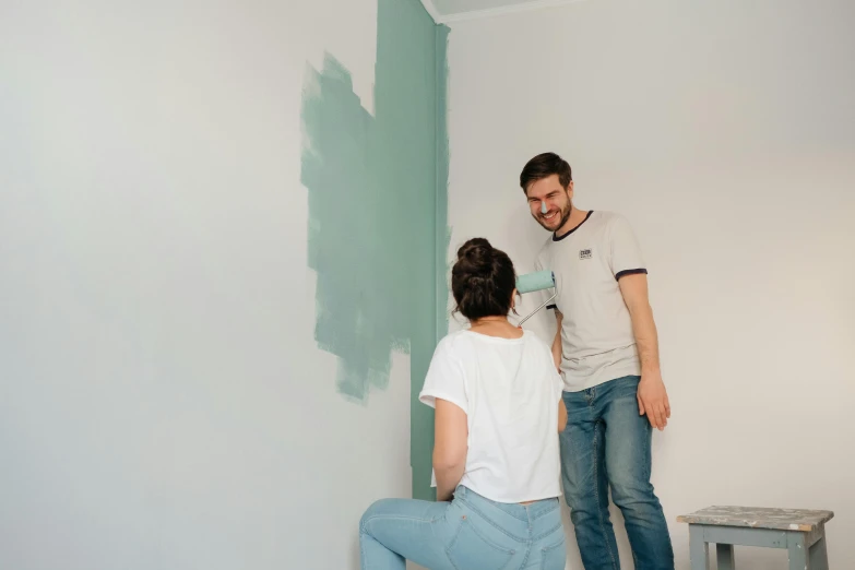 a man and a woman painting a wall, by Matthias Stom, pexels contest winner, arbeitsrat für kunst, sea green color theme, avatar image, low quality photo, white hue