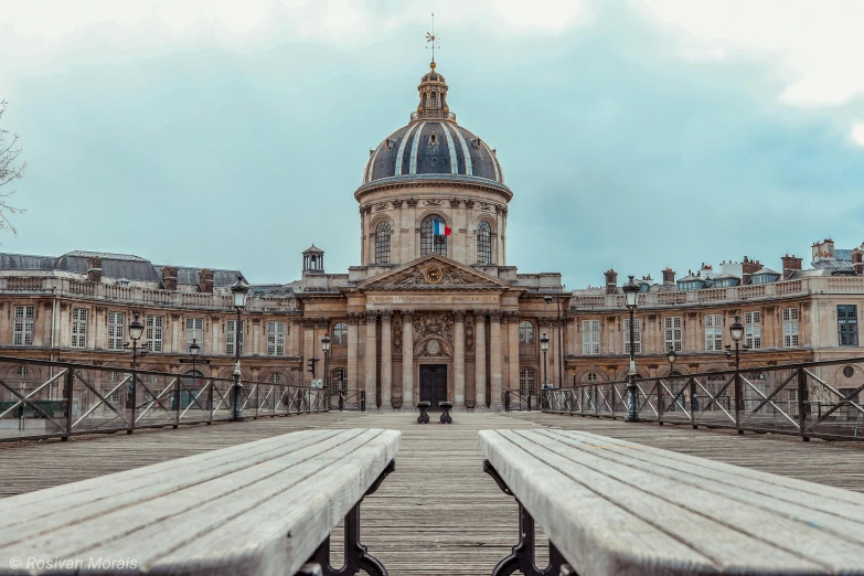 two wooden benches sitting in front of a building, a photo, unsplash contest winner, paris school, neoclassical tower with dome, 🦩🪐🐞👩🏻🦳, infinite library, profile image