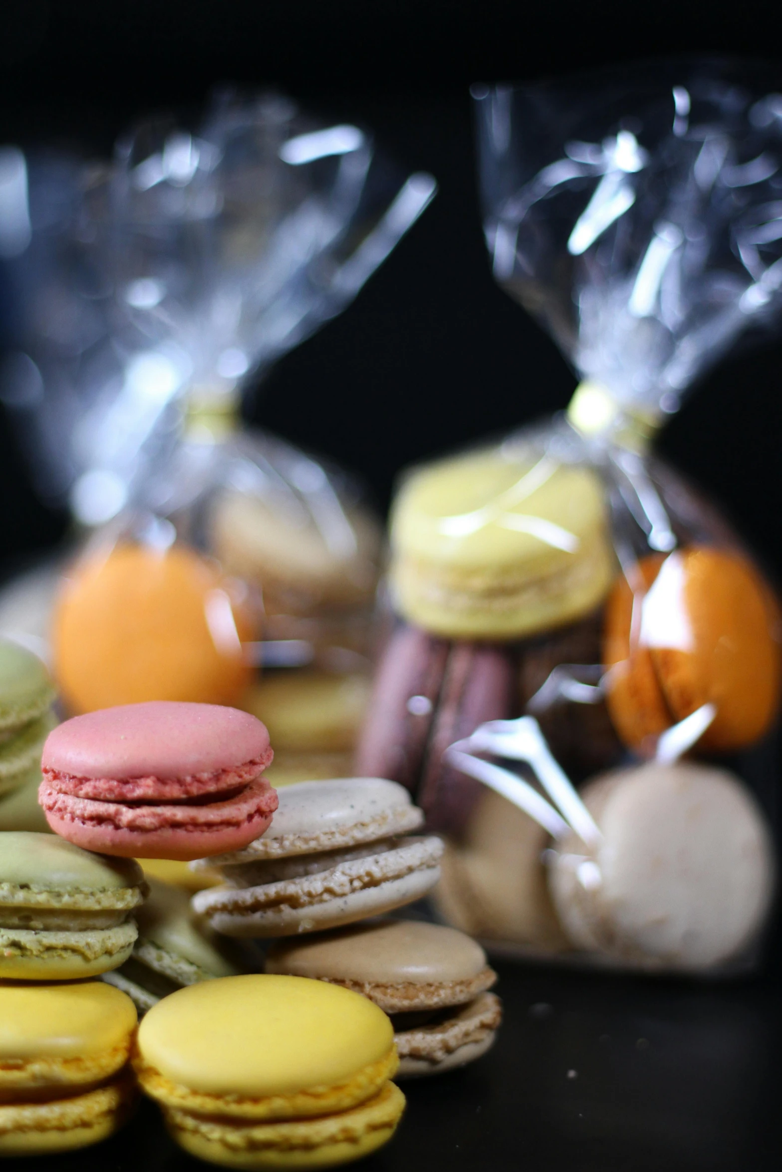 a bunch of macarons sitting on top of a table, on black background, award - winning crisp details ”, multiple colors, thumbnail