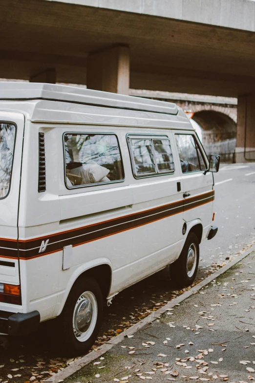 a white van parked on the side of a road, a photo, unsplash, renaissance, 1980s, 🚿🗝📝