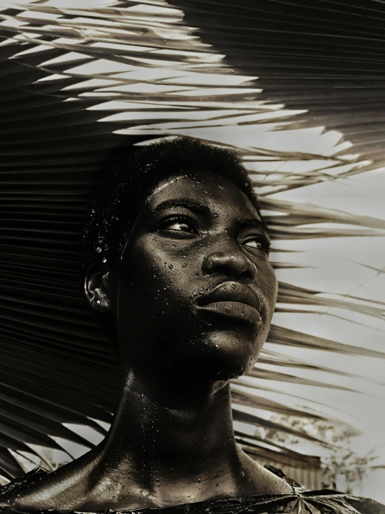 a woman standing in front of a palm tree, an album cover, by Chinwe Chukwuogo-Roy, pexels contest winner, afrofuturism, portrait of metallic face, dark and white, a photo of a man, translucent skin