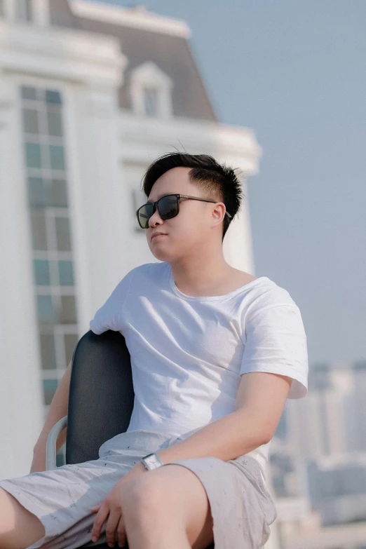a man sitting on a scooter in front of a building, inspired by Ryan Yee, pexels contest winner, wearing shades, in white room, discord profile picture, dang my linh