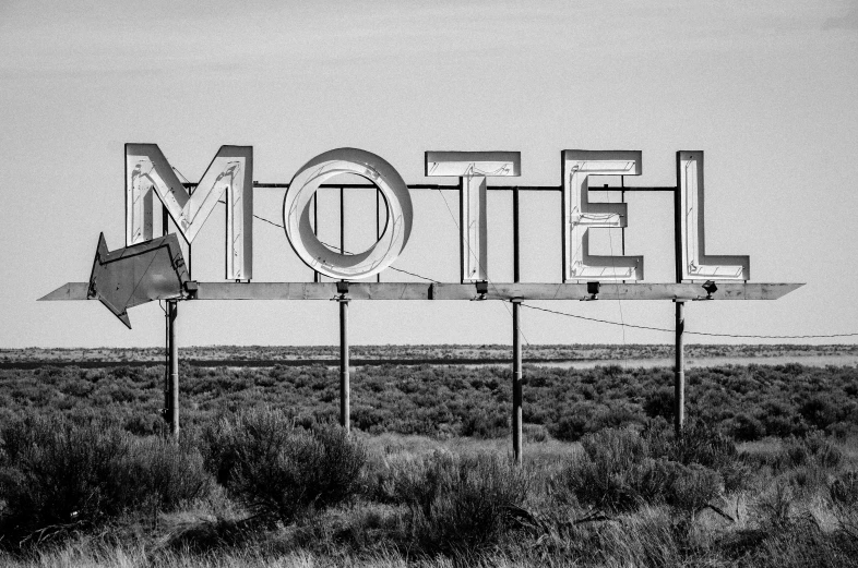 a black and white photo of a motel sign, by Matt Cavotta, pexels, retrofuturism, 🚿🗝📝, fine art print, rural wastelands, broken neon signs