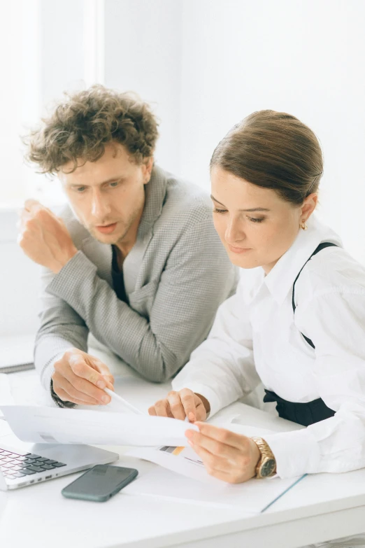 a couple of people that are sitting at a table, on desk