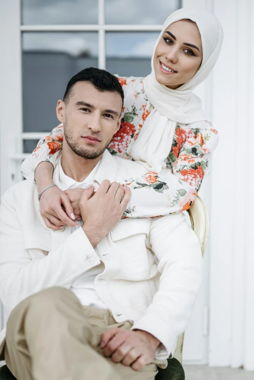 a man and a woman are posing for a picture, inspired by Nadim Karam, trending on pexels, hurufiyya, white scarf, floral clothes, maxim sukharev, dominance