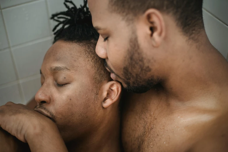 a couple of men standing next to each other, trending on pexels, intimate holding close, with grey skin, ebony, multi - coloured