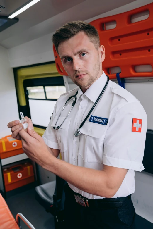 a man with a stethoscope in his hand, by Adam Marczyński, pexels, happening, wearing a police uniform, offering the viewer a pill, ambulance, soccer players timo werner