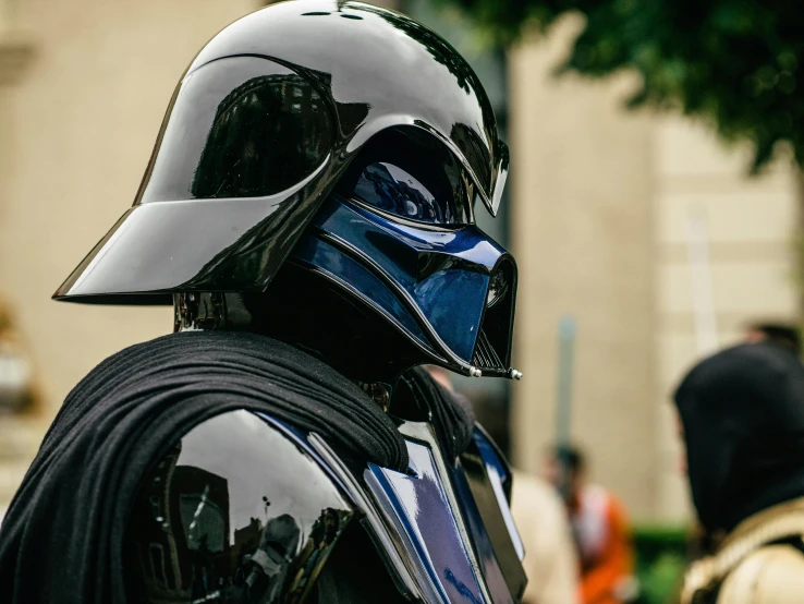 a close up of a person wearing a darth vader helmet, unsplash, costume with blue accents, delightful surroundings, avatar image, black shiny armor