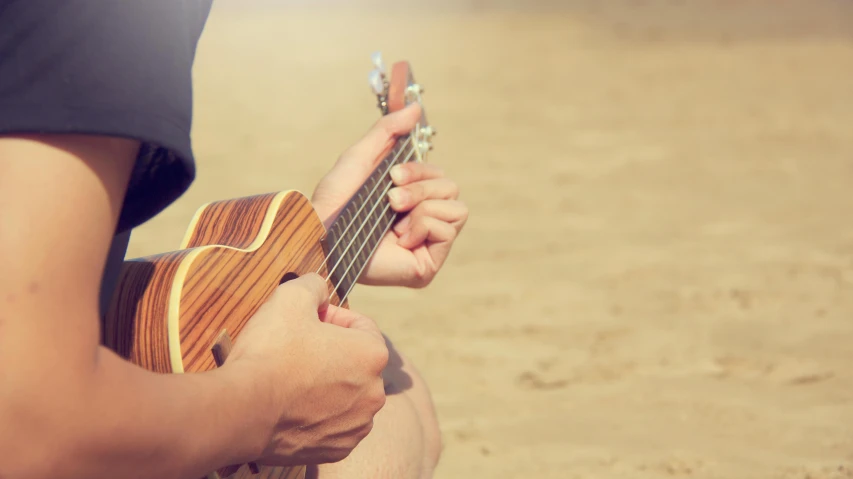 a close up of a person playing a guitar, unsplash, romanticism, on a sunny beach, ukulele, 15081959 21121991 01012000 4k, vintage style