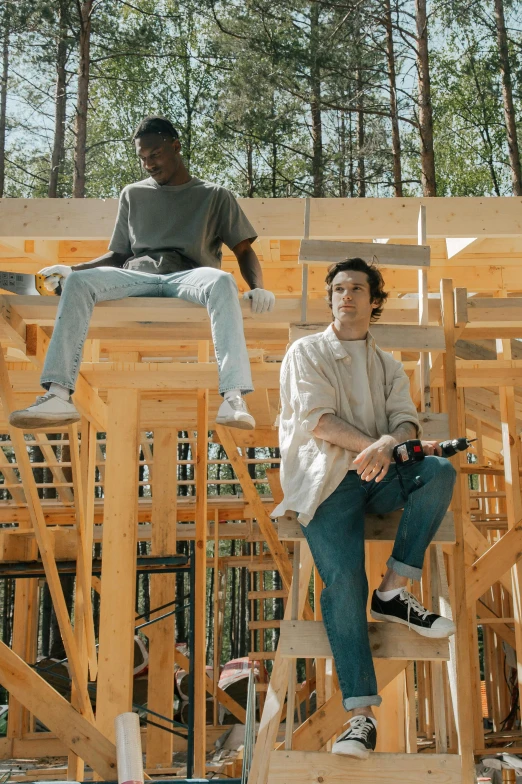 a couple of people sitting on top of a wooden structure, 2 1 savage, profile image, offwhite, construction