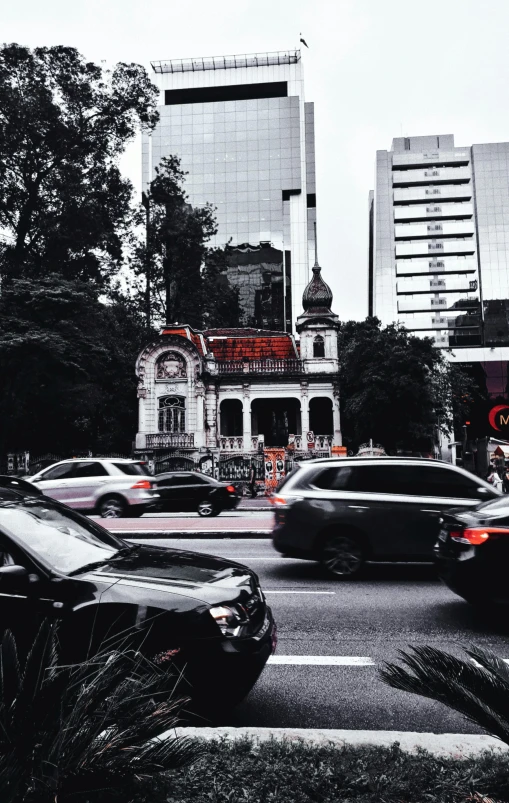 a street filled with lots of traffic next to tall buildings, a black and white photo, pexels contest winner, art nouveau, vietnam, background image, mexico city, black car