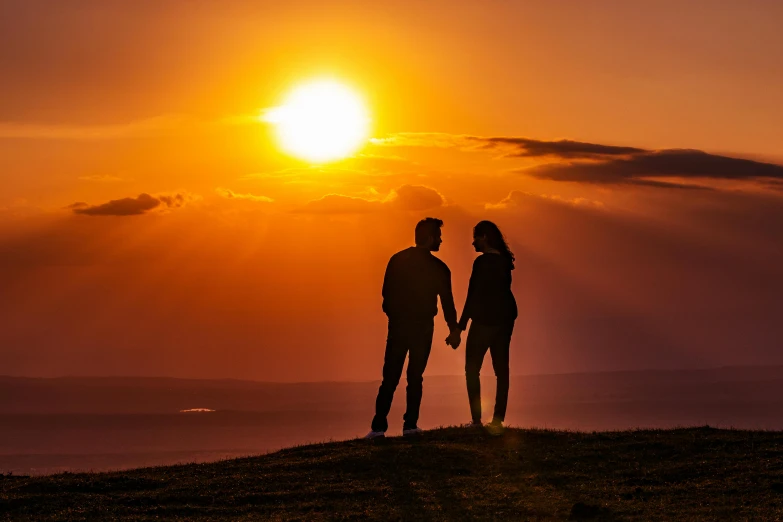 a couple standing on top of a hill at sunset, by Jesper Knudsen, pexels contest winner, romanticism, afternoon sun, ((sunset)), handsome, single