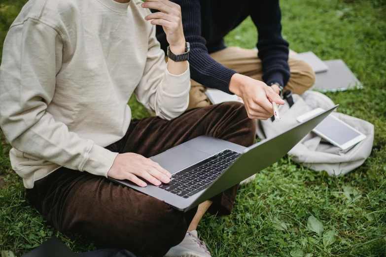 a couple of people sitting in the grass with laptops, trending on pexels, holding pencil, sydney park, thumbnail, pc screen image