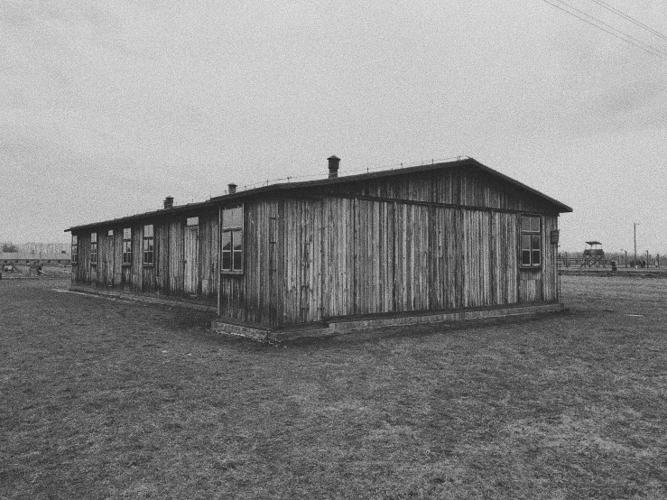 a black and white photo of a small building, auschwitz camp, rustic yet enormous scp (secure, 256x256, long view