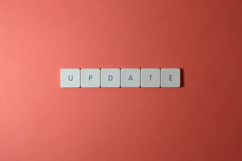 the word update spelled in white tiles on a pink background, a picture, by Carey Morris, trending on pexels, happening, gaming, slate, plain background, hr