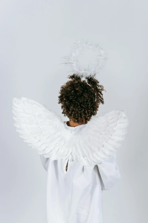 a little girl dressed up as an angel, pexels, on a gray background, detailed feathers, 15081959 21121991 01012000 4k, medium shot taken from behind