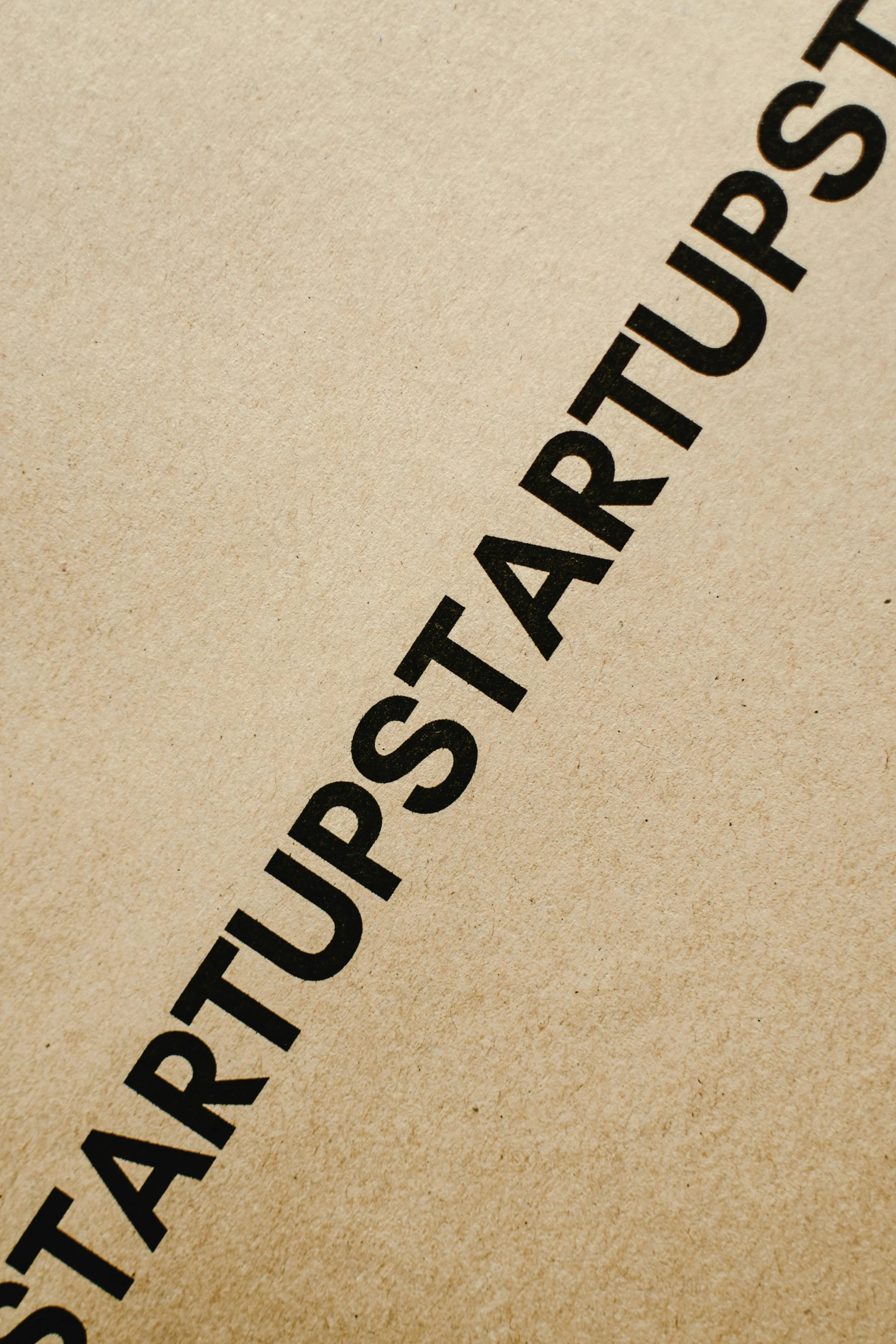 a cardboard box with the word startup written on it, an album cover, stark contrast, demur, ap, up close image