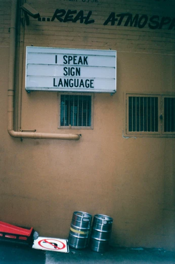 a sign that is on the side of a building, unsplash, art & language, speakers, tongue, stephen shore, - i
