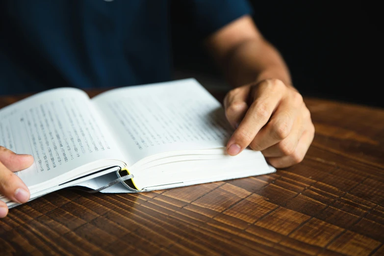 a person sitting at a table reading a book, pexels contest winner, crisp detail, teaching, background image, full body close-up shot