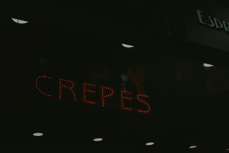 a sign that is on the side of a building, inspired by Cricorps Grégoire, pexels contest winner, red led eyes, dessert, spotlights from ceiling, staples