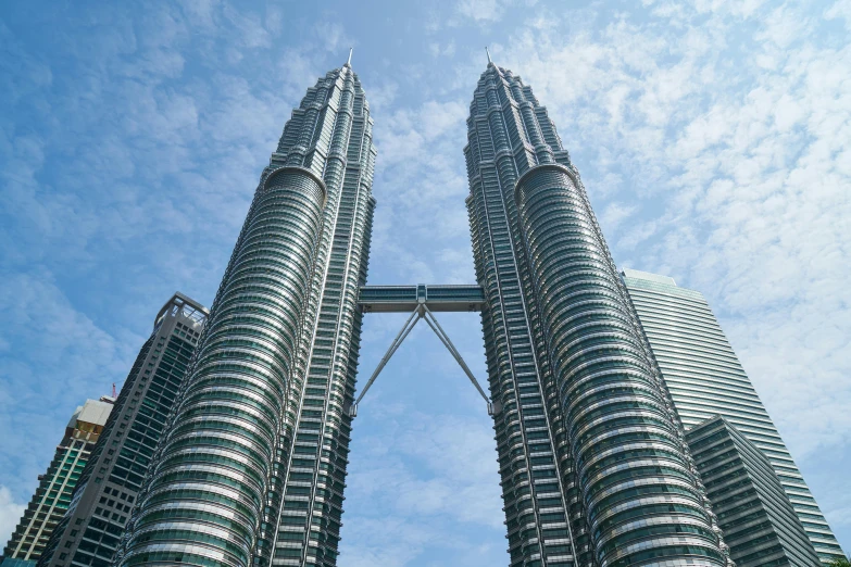 a couple of tall buildings sitting next to each other, by Bernardino Mei, pexels contest winner, hurufiyya, malaysian, renzo piano, 🦩🪐🐞👩🏻🦳, monumental structures