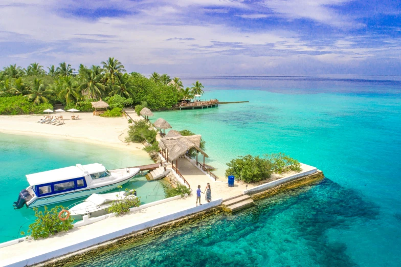 a boat sitting on top of a sandy beach next to a body of water, a photo, coral reefs, on a super yacht, resort, 2 people