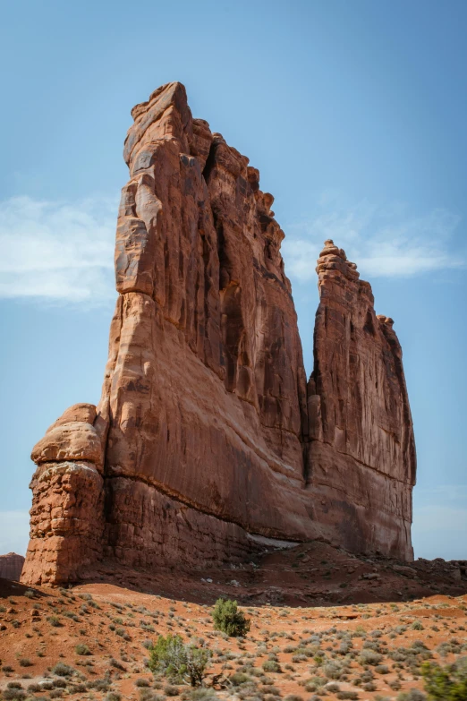 a large rock formation in the middle of a desert, tall arches, ben ridgway, telephoto shot, slide show