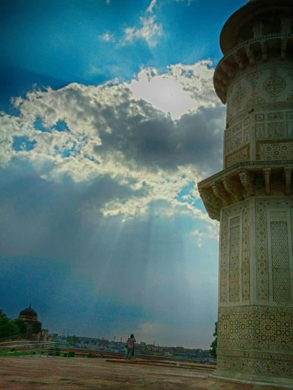 a tall tower sitting in the middle of a field, unsplash contest winner, renaissance, taj mahal, shaft of light, panorama view of the sky, low angle photo